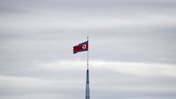 FILE PHOTO: A North Korean flag flutters on top of a 160-metre tower in North Korea's propaganda village of Gijungdong,