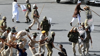 Police baton charge protesters after clashes broke out between two communities, in Jodhpur on Tuesday. (ANI Photo) (Sunil Verma)