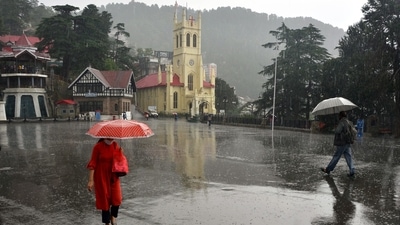 People walk under umbrellas amid heavy rainfall, at Ridge, in Shimla on Wednesday. (ANI Photo) People walk under umbrellas amid heavy rainfall, at Ridge, in Shimla on Wednesday. (ANI Photo)