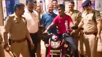 The image, taken from the Twitter video, show the policemen with the delivery boy to whom they gifted a bike. (Twitter/@mohdept)