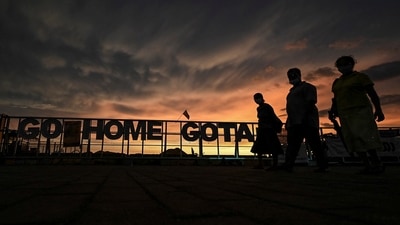 Protesters walk past a sign reading 'Go Home Gota' during an ongoing anti-government demonstration near the president's office in Colombo. (AFP) Protesters walk past a sign reading 'Go Home Gota' during an ongoing anti-government demonstration near the president's office in Colombo. (AFP)
