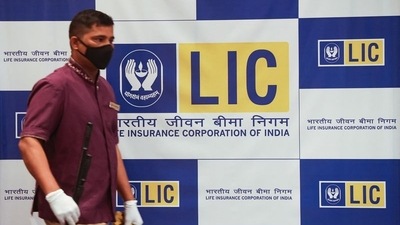 A man walks past a hoarding of Life Insurance Corporation of India (LIC) in Mumbai. (REUTERS file)