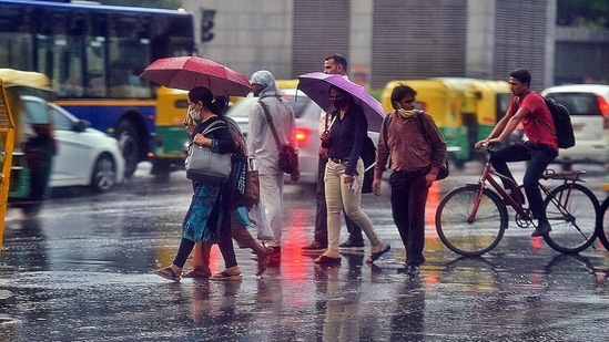 Commuters rushing to cross the road amid evening rains, at dariya Ganj Area in New Delhi, India,( Raj K Raj / Hindustan Times))
