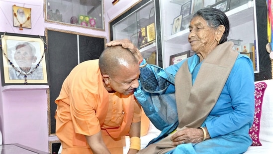 Uttar Pradesh Chief Minister Yogi Adityanath seeks blessings from his mother Savitra Devi, during their meeting, at his ancestral Panchur village in Pauri Garhwal.(PTI via Twitter)