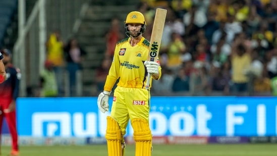 Pune: Devon Conway of Chennai Super Kings raises his bat to celebrate his half-century during the 49th T20 cricket match of the Indian Premier League 2022 (IPL season 15), between the Royal Challengers Bangalore and the Chennai Super Kings, at MCA International Stadium in Pune, Wednesday, May 4, 2022. (Sportzpics for IPL/PTI Photo)(PTI05_04_2022_000237A)(PTI)