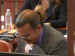 Johnny Depp laughs during the Wednesday trial. Johnny Depp laughs during the Wednesday trial.