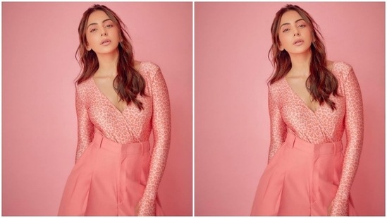 Rakul Preet stunned in this pink satin top featuring a plunging neckline teamed with high-rise baggy trousers by Monokrom.(Instagram/@rakulpreet)