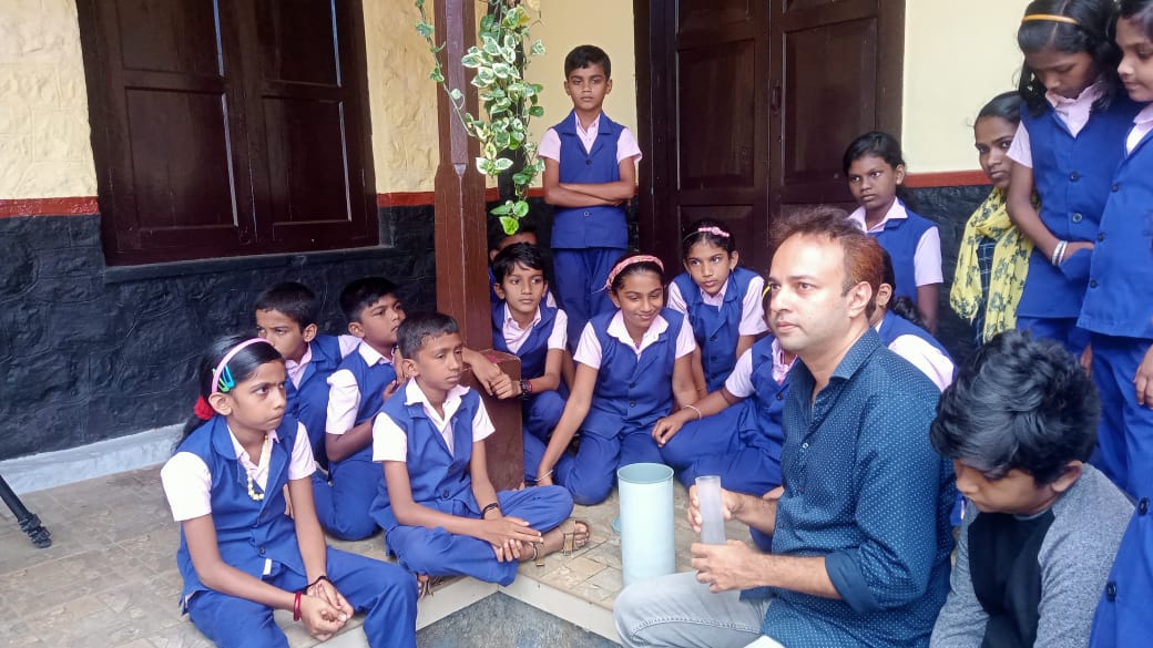 Roxy Mathew Koll, a climate scientist at the Indian Institute of Tropical Meteorology, Pune, teaches students how to set up a rain gauge.&nbsp; (Eby Immanuel)
