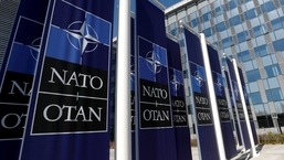 FILE PHOTO: Banners displaying the NATO logo are placed at the entrance of new NATO headquarters.