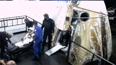 Image made from video supplied by NASA, astronaut Kayla Barron exits the SpaceX Dragon space capsule after splashing down in the Gulf of Mexico off Tampa, Florida, early Friday. (AP)