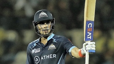 Mumbai: Shubman Gill of Gujarat Titans raises his bat to celebrate his half-century during the 51st T20 cricket match of the Indian Premier League 2022 (IPL season 15), between the Gujarat Titans and the Mumbai Indians, at Brabourne Stadium (CCI) in Mumbai, Friday, May 6, 2022. (Sportzpics for IPL/PTI Photo) (PTI05_06_2022_000241B) (PTI)