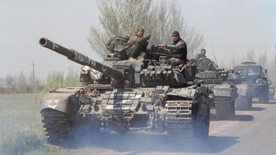 Service members of pro-Russian troops drive armoured vehicles during Ukraine-Russia conflict near Novoazovsk in the Donetsk Region, Ukraine. (REUTERS)