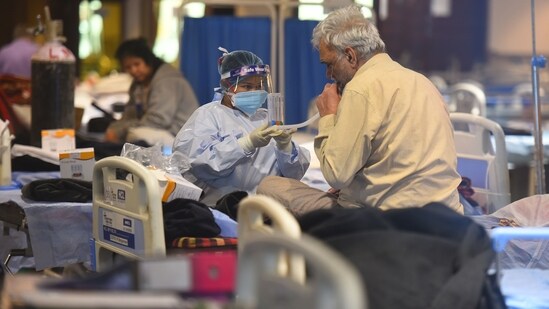 A patient being attended by a healthcare worker in Delhi Covid-19 care facility.(Raj K Raj/HT File)