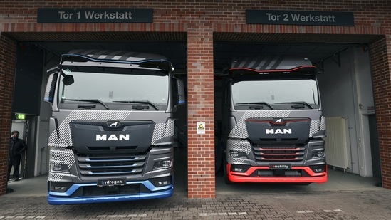The MAN SE hydrogen concept truck, left, and E-truck prototype at the company's factory in Nuremberg, Germany, on Thursday, Feb. 17, 2022. MAN hope to accelerate the company's transformation towards emission-free freight with the presentation of their near-series electric and hydrogen truck prototypes at the company headquarters. Photographer: Alex Kraus/Bloomberg(Bloomberg)
