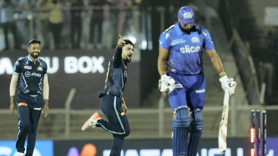 Mumbai: Rashid Khan of Gujarat Titans celebrates the wicket of Kieron Pollard of Mumbai Indians during the 51st T20 cricket match of the Indian Premier League 2022 (IPL season 15), between the Gujarat Titans and the Mumbai Indians, at Brabourne Stadium (CCI) in Mumbai, Friday, May 6, 2022. (Sportzpics for IPL/PTI Photo) (PTI05_06_2022_000212A)(PTI)