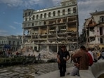 People watch the rescue effort at the site of a deadly explosion that destroyed the five-star Hotel Saratoga, in Havana, Cuba. (AP Photo/Ramon Espinosa)(AP) People watch the rescue effort at the site of a deadly explosion that destroyed the five-star Hotel Saratoga, in Havana, Cuba. (AP Photo/Ramon Espinosa)(AP)