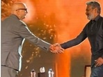 Anupam Kher and SS Rajamouli share a handshake and a hug. Anupam Kher and SS Rajamouli share a handshake and a hug.