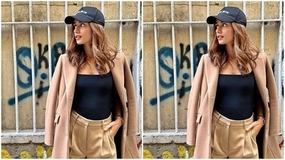Manushi teamed her get up with minimal accessories to keep the holiday look chic and fuss-free. The star opted for a Miu Miu black baseball cap, a beige coat layered on her shoulders, black and white chunky sneakers, a white mini shoulder bag, a sleek gold bracelet, and a silver metallic watch. (Instagram/@manushi_chhillar) Manushi teamed her get up with minimal accessories to keep the holiday look chic and fuss-free. The star opted for a Miu Miu black baseball cap, a beige coat layered on her shoulders, black and white chunky sneakers, a white mini shoulder bag, a sleek gold bracelet, and a silver metallic watch. (Instagram/@manushi_chhillar)