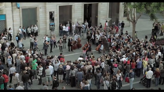 An orchestral flash mob performs the symphony at Placa de Sant Roc in Sabadell, Spain.