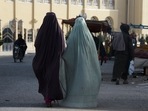 Burqa-clad women walk along a street in Kandahar.(AFP) Burqa-clad women walk along a street in Kandahar.(AFP)