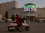 A screen shows a picture of Chinese President Xi Jinping at a traffic junction in Hotan, Xinjiang Uyghur Autonomous Region, China.