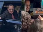 A fan handing over an entire briefcase to Johnny Depp outside the courtroom. A fan handing over an entire briefcase to Johnny Depp outside the courtroom.