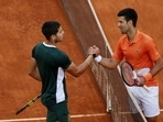 Spain's Carlos Alcaraz Garfia shakes hands with Serbia's Novak Djokovic after winning their semi final match
