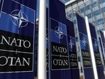 FILE PHOTO: Banners displaying the NATO logo are placed at the entrance of new NATO headquarters during the move to the new building, in Brussels, Belgium April 19, 2018.  REUTERS/Yves Herman/File Photo