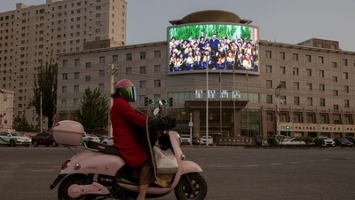 A screen shows a picture of Chinese President Xi Jinping at a traffic junction in Hotan, Xinjiang Uyghur Autonomous Region, China. (REUTERS)
