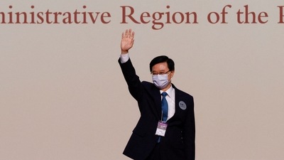 John Lee celebrates on stage after being elected as Hong Kong's Chief Executive, in Hong Kong, China. (REUTERS)