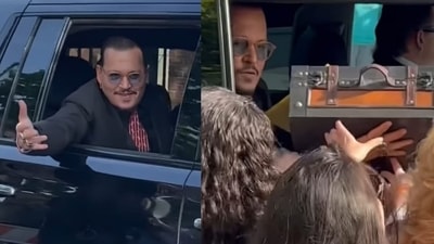 A fan handing over an entire briefcase to Johnny Depp outside the courtroom. A fan handing over an entire briefcase to Johnny Depp outside the courtroom.