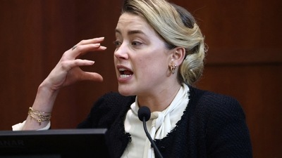 Amber Heard reacts on the stand during during a defamation case against her by ex-husband, actor Johnny Depp. (Jim Lo Scalzo/Pool via REUTERS) (REUTERS)