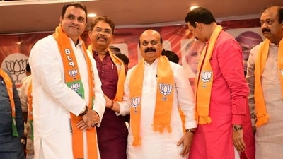 Pramod Madhwaraj joins the BJP along with other party leaders in the presence of Karnataka chief minister Basavaraj Bommai.