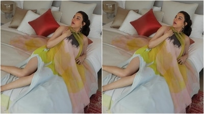 The pictures show Kajal lounging on a bed in a hotel room and striking different poses for the camera. She wore a multi-coloured printed dress for the occasion and teamed it with minimal accessories. (Instagram/@kajalaggarwalofficial) The pictures show Kajal lounging on a bed in a hotel room and striking different poses for the camera. She wore a multi-coloured printed dress for the occasion and teamed it with minimal accessories. (Instagram/@kajalaggarwalofficial)