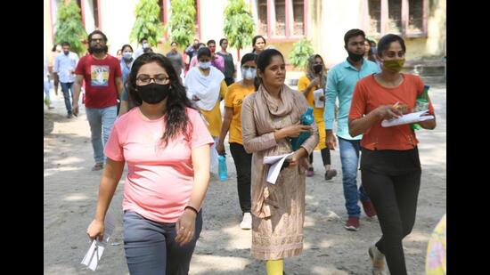 Aspirants leave after appearing for the BPSC exam in Patna on Sunday. (Santosh Kumar/HT Photo)