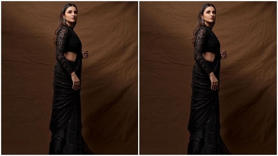 Parineeti's black sheer saree is from the shelves of the clothing label JADE by Monica and Karishma. It comes adorned with horizontal sequinned lines embroidered all over the drape, scalloped borders with chikankari embroidery, and intricate lace details on the border and pallu.(Instagram/@parineetichopra)