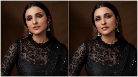 Parineeti wore the six yards in the traditional draping style, hugging her curvy frame, the pallu grazing the floor and the saree revealing her midriff. She teamed it with a matching black blouse featuring long sheer lace sleeves, floral embroidery and a ruffled neckline.(Instagram/@parineetichopra)