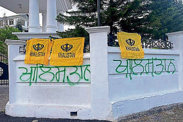 Khalistan flags were found tied to the main gate and separatist slogans scrawled on the boundary walls of the HP Legislative Assembly complex near Dharamshala on May 8. (HT PHOTO) Khalistan flags were found tied to the main gate and separatist slogans scrawled on the boundary walls of the HP Legislative Assembly complex near Dharamshala on May 8. (HT PHOTO)