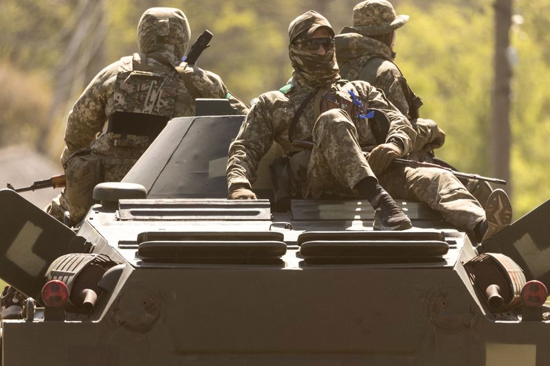 Ukrainian soldiers ride on an armored vehicle enroute to the front line, amid Russia's invasion in Ukraine, in Bakhmut in the Donetsk region on May 8, 2022.&nbsp; (Reuters photo)