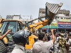 Municipal Corporation of Delhi (MCD) workers in presence of Delhi Police during an anti-encroachment drive, at Shaheen Bagh area in New Delhi.(PTI)