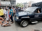 People block a road as they wait for the gas trucks to arrive at the station to distribute for them amid the country's economic crisis in Colombo,&nbsp;