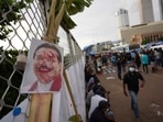 A disfigured portrait of Prime Minister Mahinda Rajapaksa is seen at a protest site outside president's office in Colombo, Sri Lanka. A disfigured portrait of Prime Minister Mahinda Rajapaksa is seen at a protest site outside president's office in Colombo, Sri Lanka.