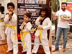Taimur Ali Khan, Kareena Kapoor, Saif Ali Khan strike a taekwondo pose.