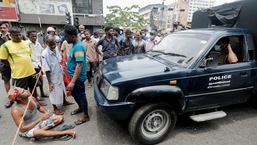 People block a road as they wait for the gas trucks to arrive at the station to distribute for them amid the country's economic crisis in Colombo,&nbsp;
