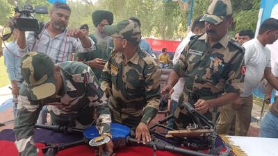 Border Security Force personnel displaying the drone from Pakistan that was shot down near Bharopal village of Amritsar district on Monday. The BSF also recovered 10.6kg of heroin it was carrying. (Sameer Sehgal/HT) Border Security Force personnel displaying the drone from Pakistan that was shot down near Bharopal village of Amritsar district on Monday. The BSF also recovered 10.6kg of heroin it was carrying. (Sameer Sehgal/HT)
