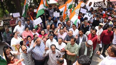 Congress workers protesting against the state government on paper leak case outside the deputy commissioner's office in Shimla on Monday. (Deepak Sansta/Hindustan Times)