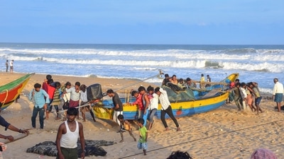 Fishermen park their boat on the shore after India Meteorological Department issued an alert for coastal states regarding Cyclone Asani, at Puri beach. (PTI) Fishermen park their boat on the shore after India Meteorological Department issued an alert for coastal states regarding Cyclone Asani, at Puri beach. (PTI)