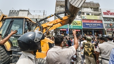 Municipal Corporation of Delhi (MCD) workers in presence of Delhi Police during an anti-encroachment drive, at Shaheen Bagh area in New Delhi. (PTI)