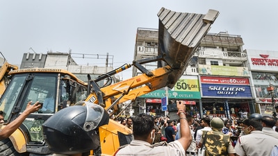 Municipal Corporation of Delhi (MCD) workers in presence of Delhi Police during an anti-encroachment drive, at Shaheen Bagh area in New Delhi. (PTI)