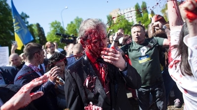 Russian Ambassador to Poland, Ambassador Sergey Andreev is covered with red paint in Warsaw, Poland. (AP)